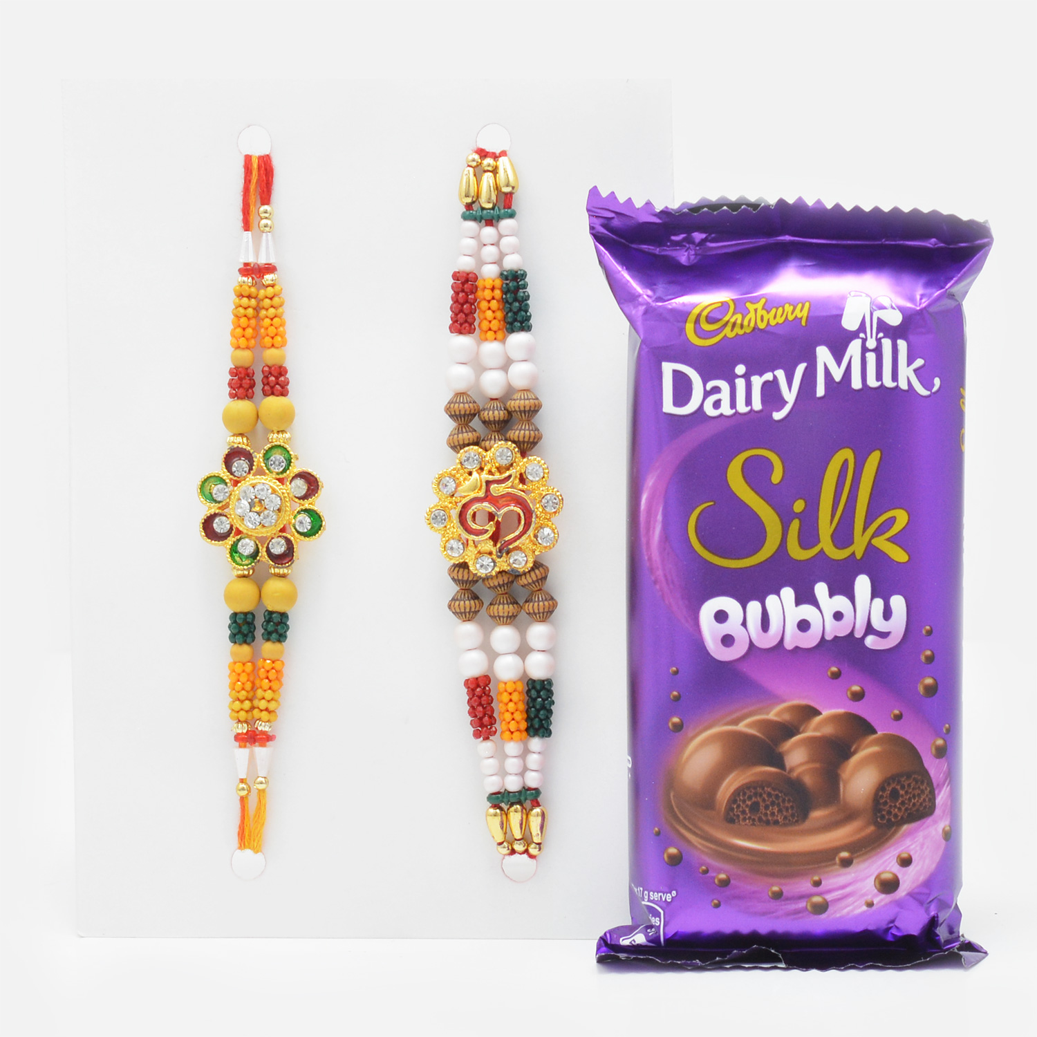 Heavy Pearl and Sandalwood Work Rakhi Set of 2 with Tempting Cadbury Daiy Milk Silk Bubbly