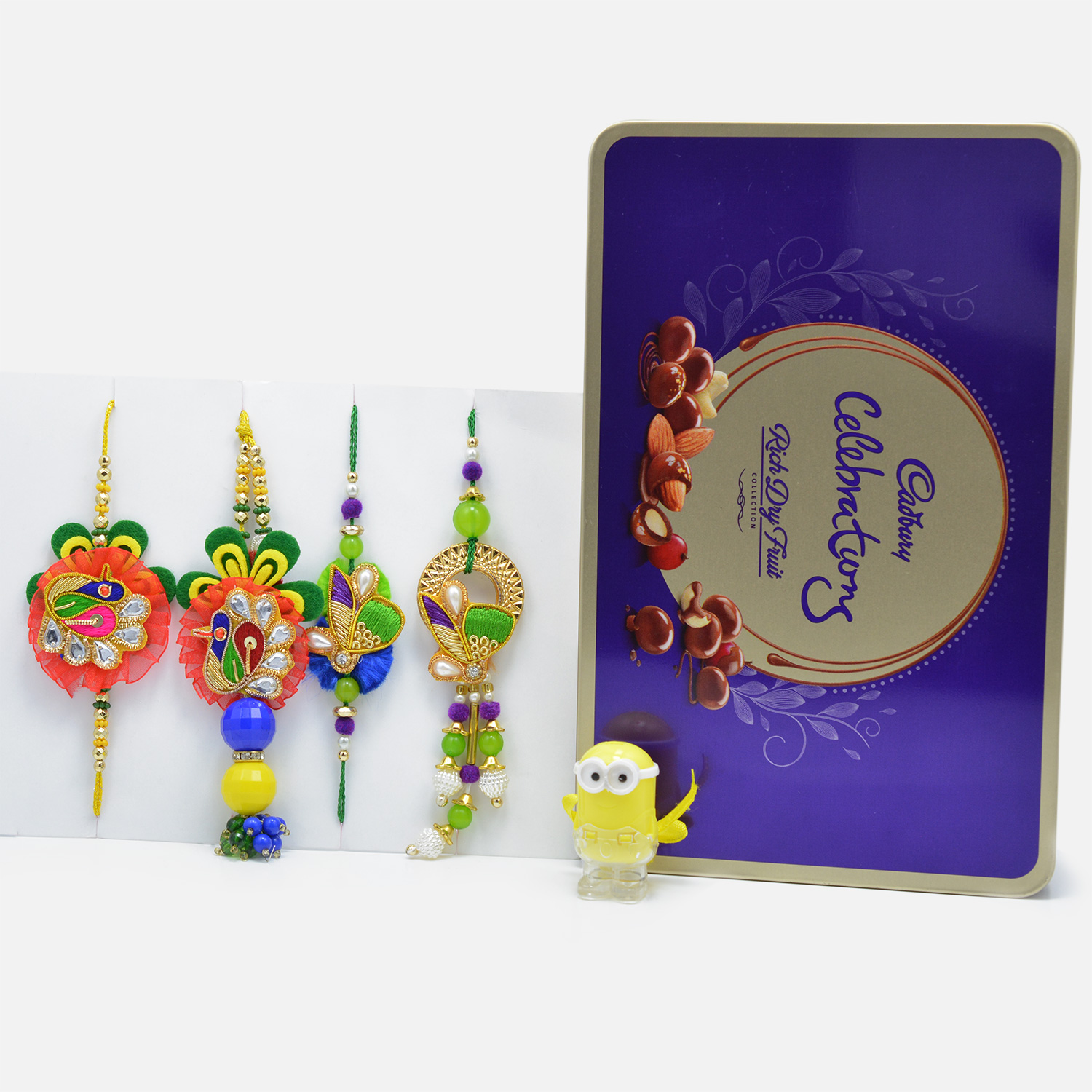 Designer Zardozi Rakhi Set of 4 for Bhaiya-Bhabhi and LED Minion Kids Rakhi with Tempting Cadbury Celebration Rich Dry Fruit Chocolate Collection