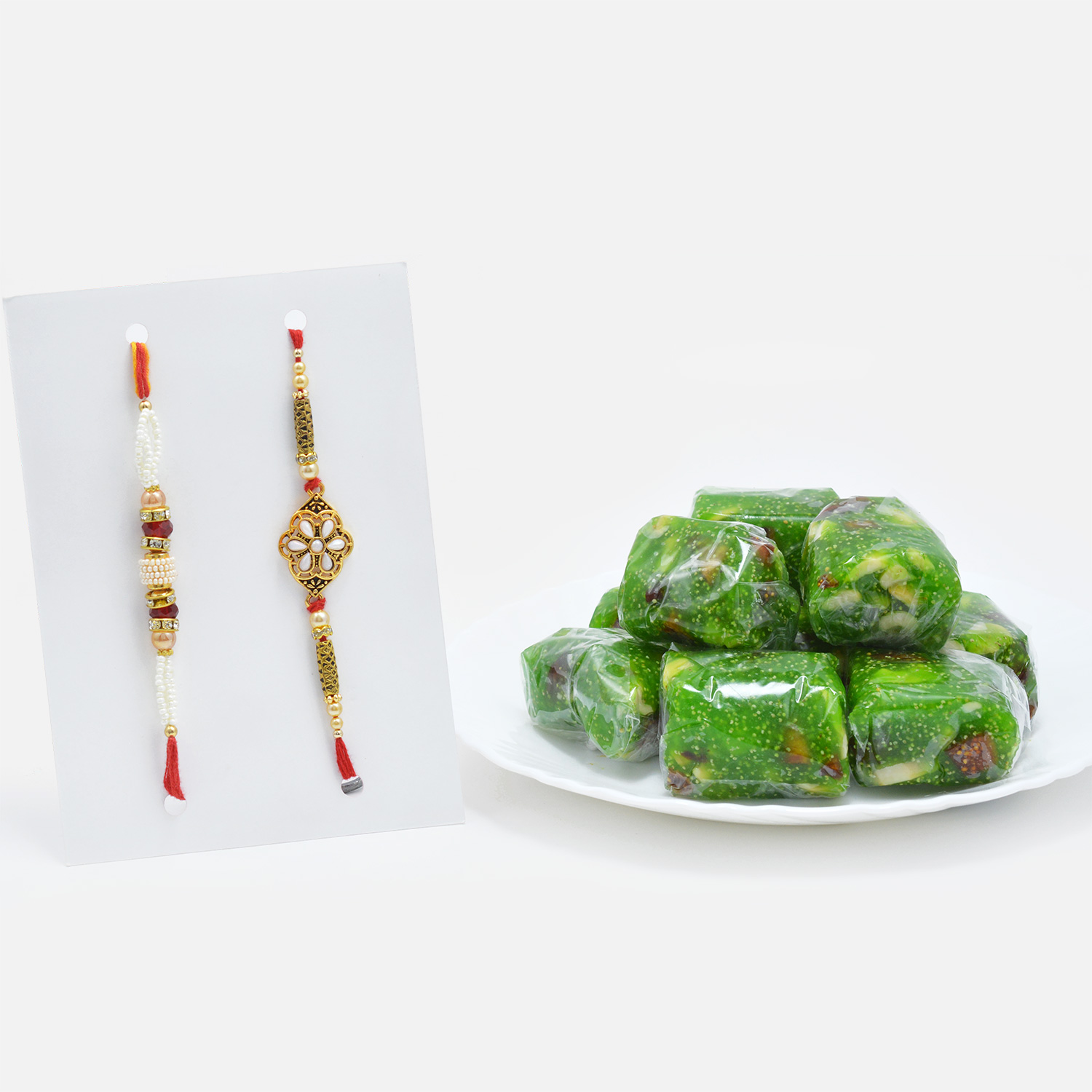 Elegant Pearls Rakhi Set of 2 with Tempting Kaju Anjeer Dryfruits