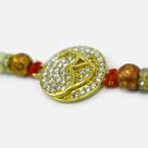 Golden Emerged Om Surrounded with Jewel Special Pearl God Rakhi for Brother