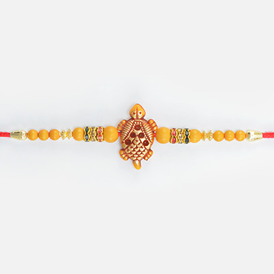 Good Luck Tortoise in Mid with Colorful Jewel and Simple Beads in Mauli Amazing Looking Rakhi for Brother