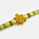 Simple Liner Beads Rakhi of Good Luck Om Written Tortoise Special Raksha Bandhan Rakhi