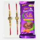 Auspicious Two Swastika Rakhis with Dairy Milk Roast Almond Chocolate