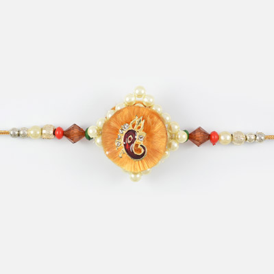 Attractive golden look of Lord Ganesha with pearl at base and colorful gems Rakhi