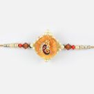 Attractive golden look of Lord Ganesha with pearl at base and colorful gems Rakhi