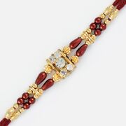 Golden Grace with Diamonds and Maroon Beads Fancy Rakhi