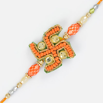 Auspicious green swastik with orange beads and kundan work