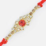 Magnificent Design of Golden Base with Central Studded Red Diamond Rakhi