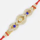 Oval Shape Central Studded Red Diamond Base Jewel Rakhi 