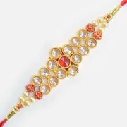 Awesome Looking Transparent and Red Jewel Studded Golden Color Amazing Jewel Rakhi