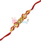 Fancy Diamond Rakhi with Red Beads Sorrounding Sandalwood Beads