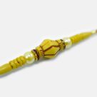 Attractive Looking Liner Pearl and Bead Mauli Rakhi for Brother