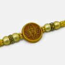 Shri Ganesha Emerged on Wood Golden Color Beaded Pearl Rakhi