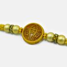 Shri Ganesha Emerged on Wood Golden Color Beaded Pearl Rakhi