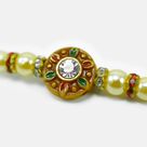 Jewel In Mid of Meena Work Base Stunning Looking Pearl Rakhi