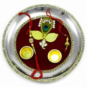 Lord Ganesha Rakhi Pooja Thali on Maroon Base Adorned with Mor Pankh