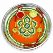 Uniquely Designed Center on Orange Painted Rakhi Pooja Thali