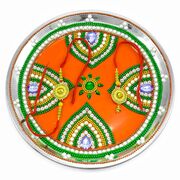Petal-Crafted Rakhi Pooja Thali with Colorful Chain and Small Flower Center on an Orange Base