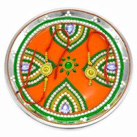 Petal-Crafted Rakhi Pooja Thali with Colorful Chain and Small Flower Center on an Orange Base