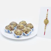 Stunning Golden OM Rakhi with Flavourful Dry Fruit Laddu